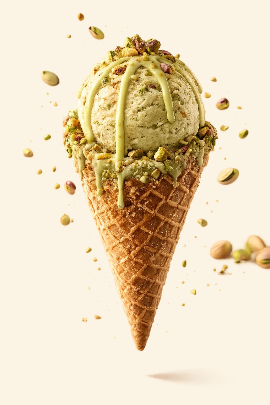 A KreemiK Sicilian Pistachio scoop on a waffle cone